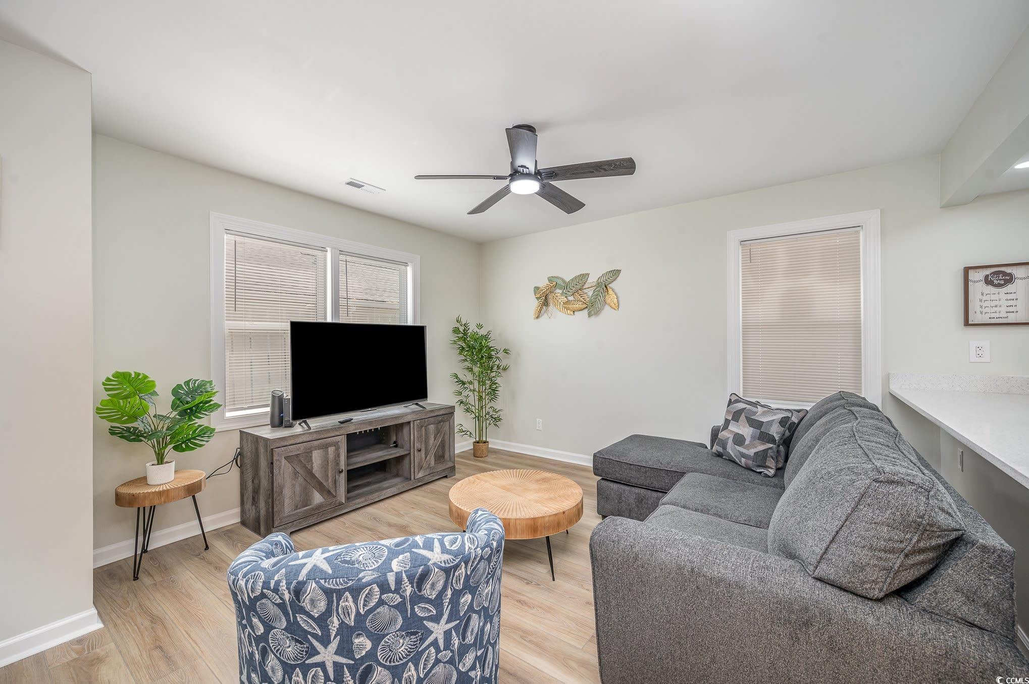 Image 4: Living area featuring light wood-type flooring and
