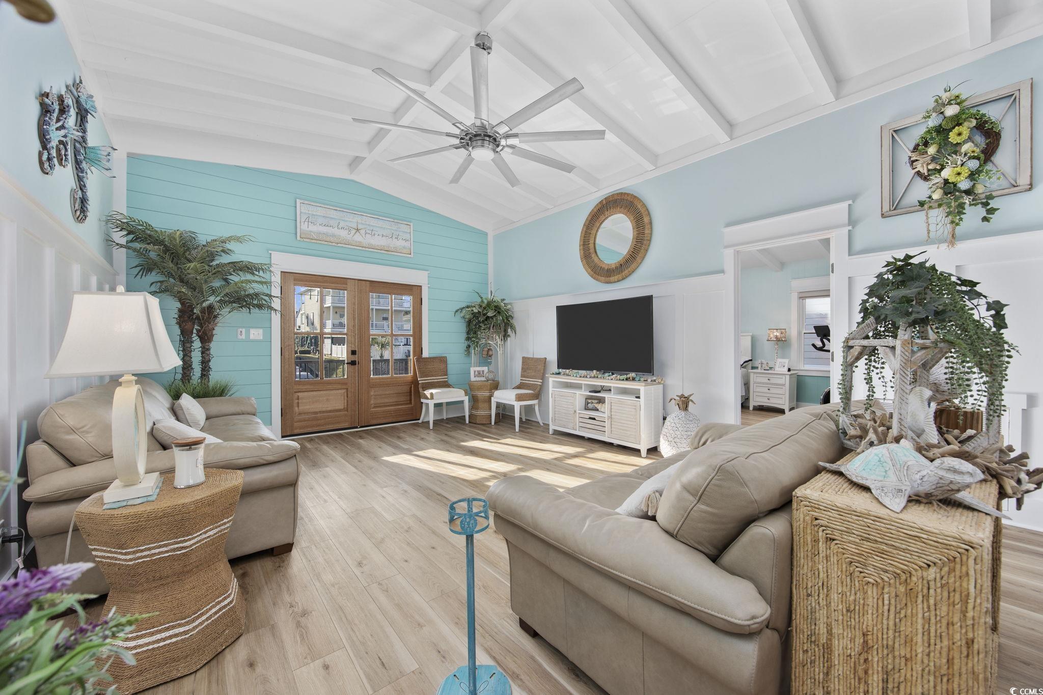 Image 4: Living area with french doors, hardwood / wood-sty