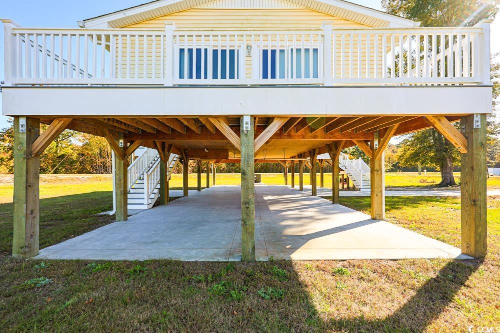 Image 3: Surrounding community with a deck, a carport, stai Image 3: Surrounding community with a deck, a carport, stai
