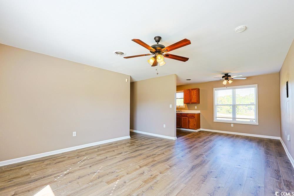 Image 4: Unfurnished living room featuring light wood-type Image 4: Unfurnished living room featuring light wood-type