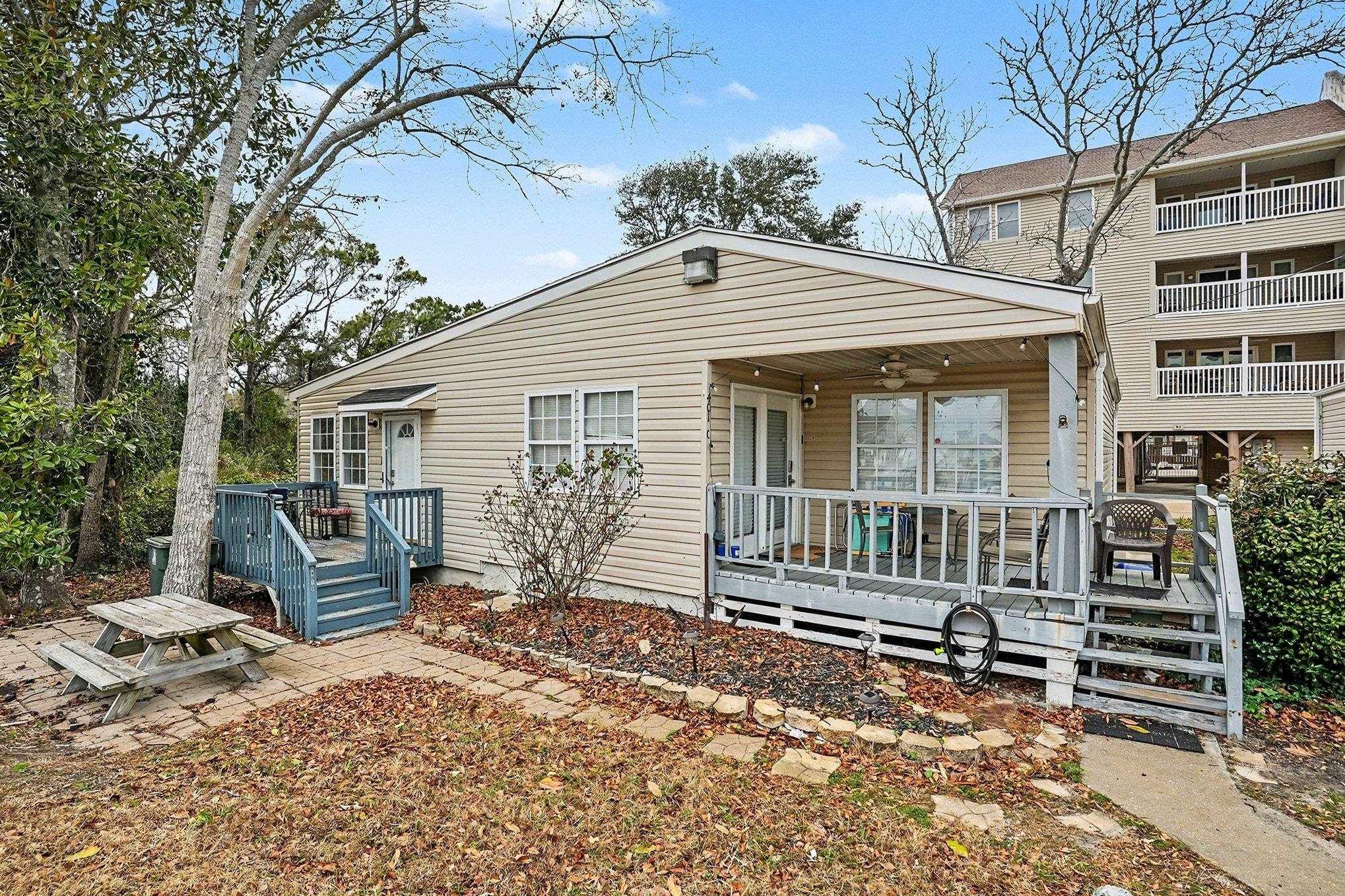 Image 1: View of front of property featuring a deck and cei Image 1: View of front of property featuring a deck and cei