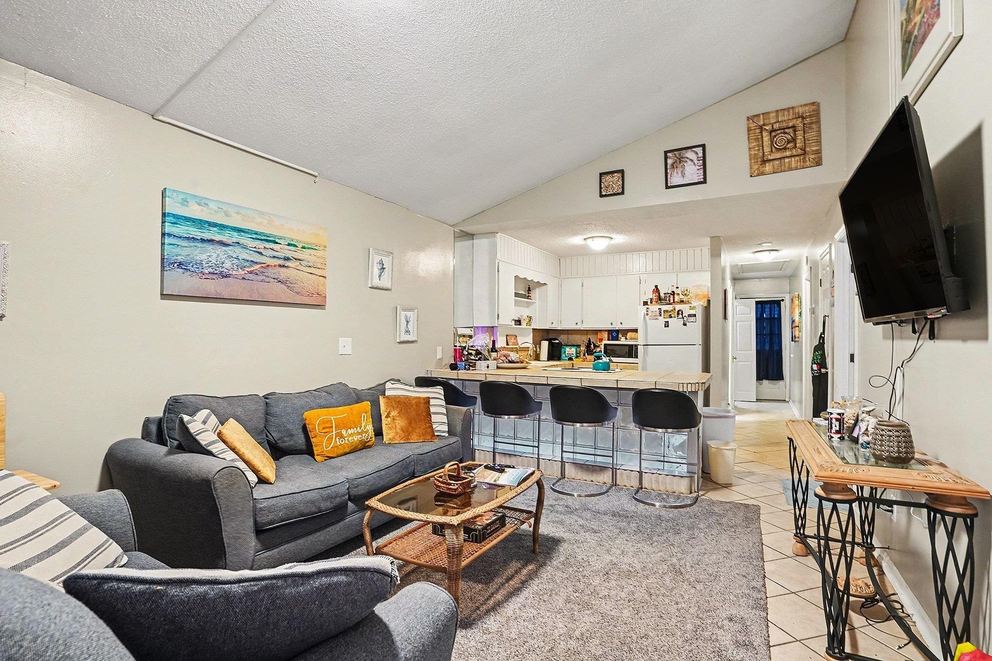 Image 3: Living room with light tile patterned floors, vaul Image 3: Living room with light tile patterned floors, vaul