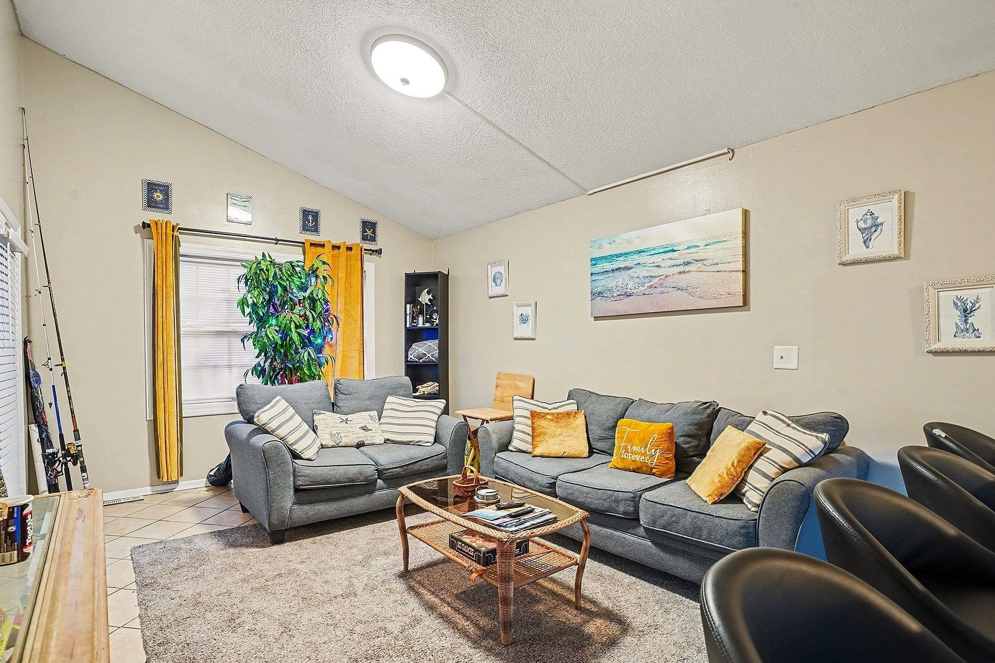 Image 4: Living area with a textured ceiling, light tile pa Image 4: Living area with a textured ceiling, light tile pa
