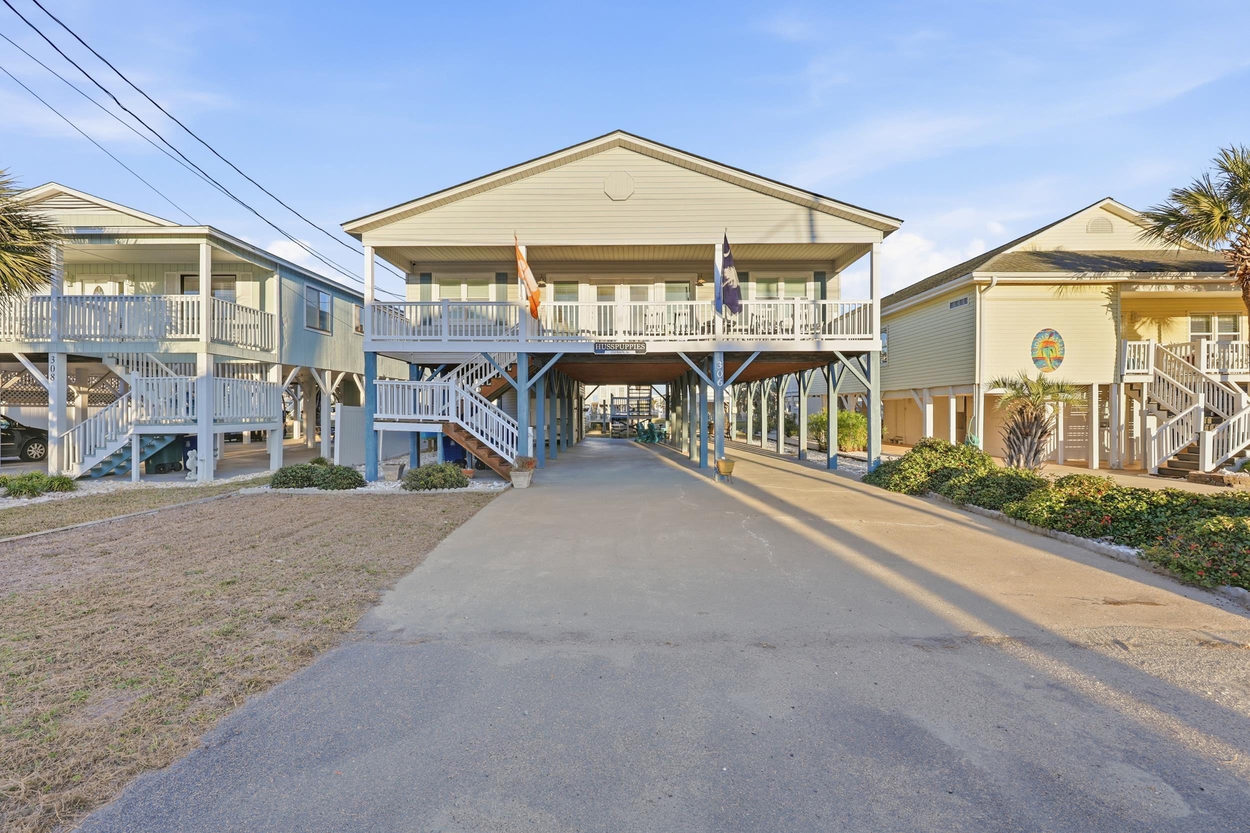 Image 1: View of building exterior with a carport, stairs, Image 1: View of building exterior with a carport, stairs,