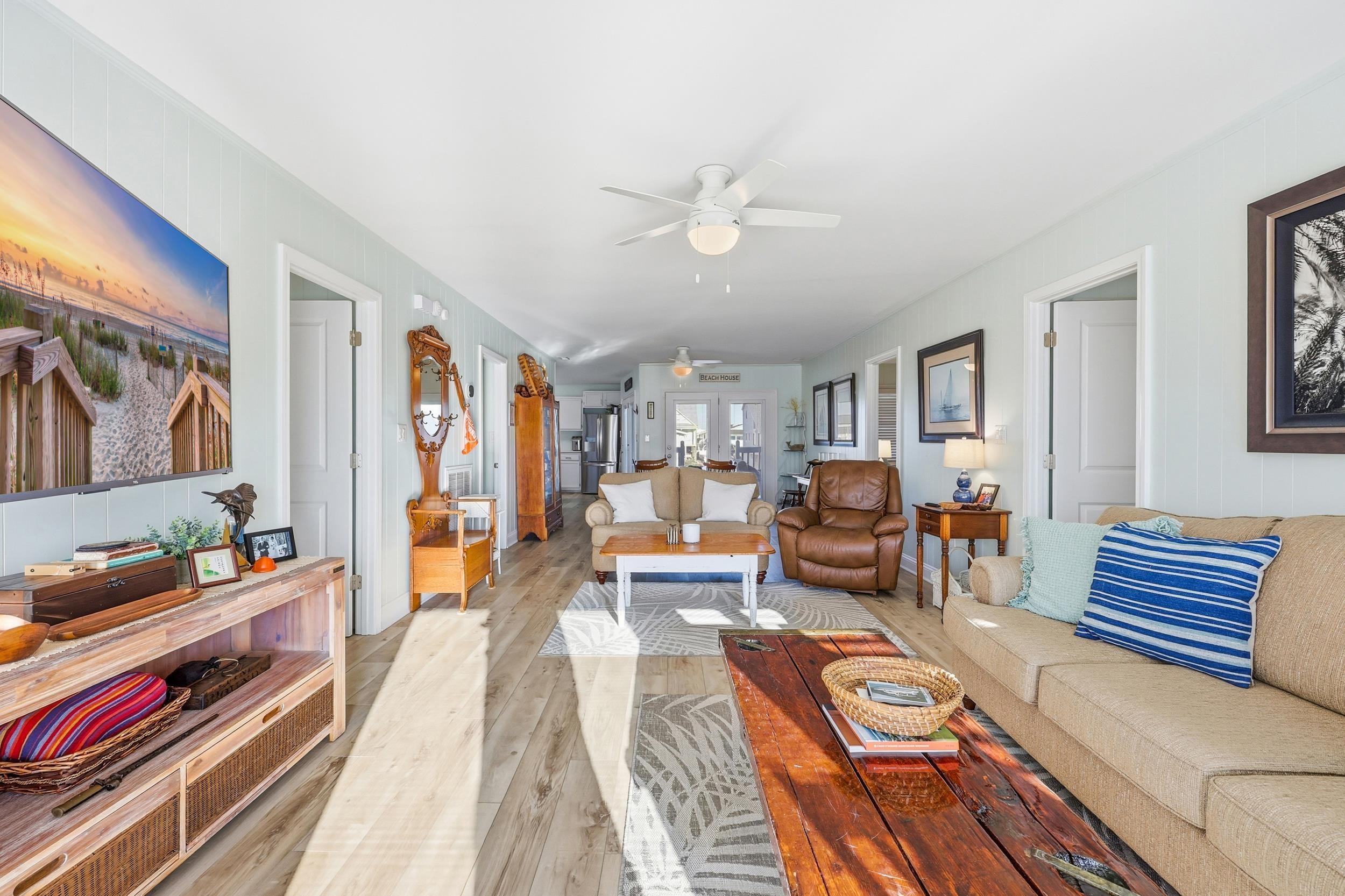Image 2: Living room featuring a ceiling fan and wood finis Image 2: Living room featuring a ceiling fan and wood finis