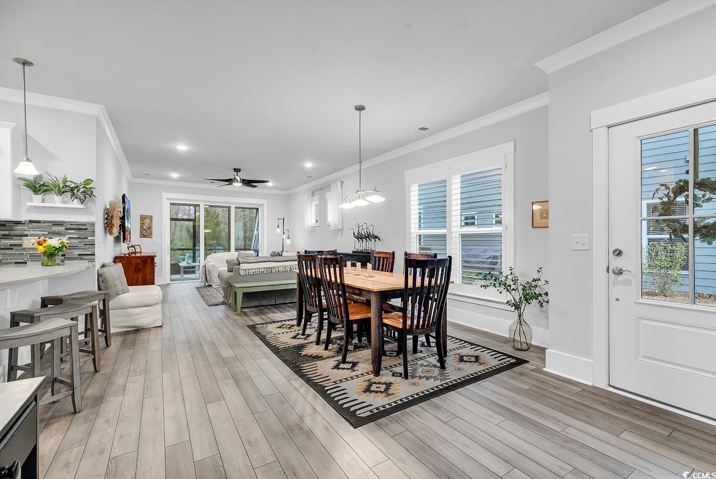 Image 2: Dining space featuring crown molding, light wood-s Image 2: Dining space featuring crown molding, light wood-s