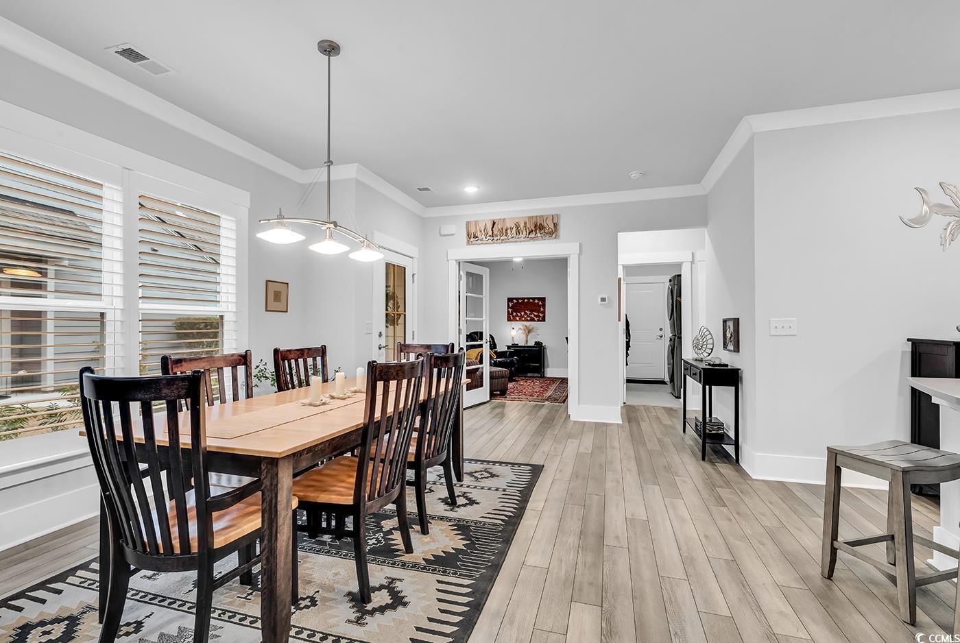 Image 3: Dining space with ornamental molding and light woo Image 3: Dining space with ornamental molding and light woo