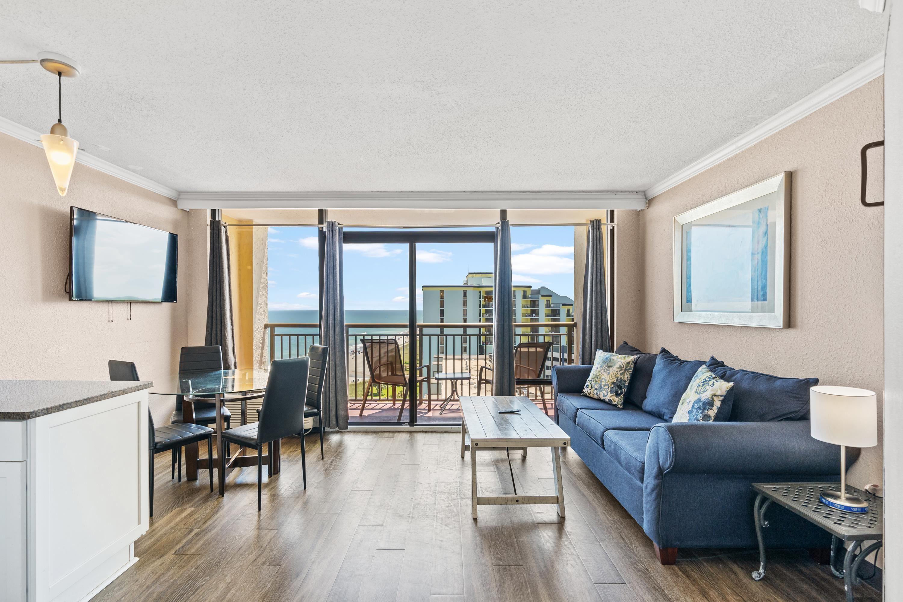 Image 3: Living room with floor to ceiling windows, crown m