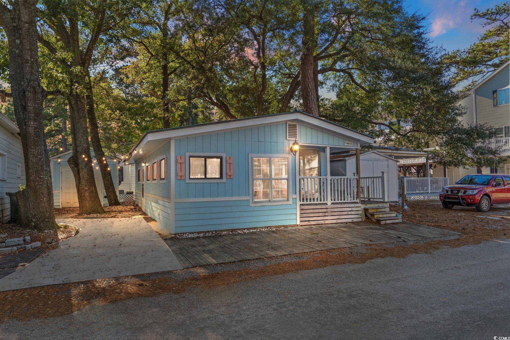 Image 1: View of front of home with a storage shed Image 1: View of front of home with a storage shed