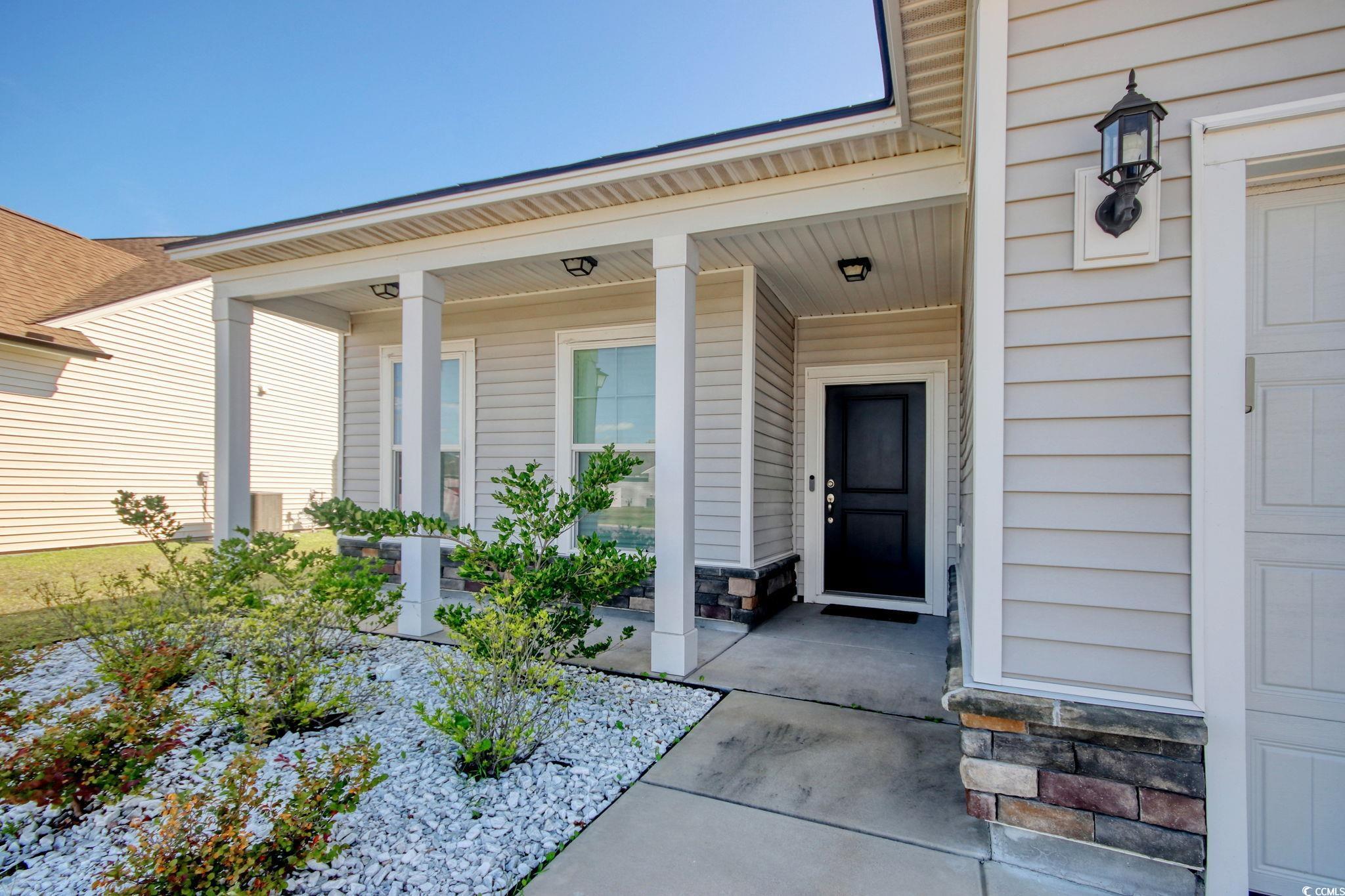 Image 4: Entrance to property with a porch and stone siding Image 4: Entrance to property with a porch and stone siding