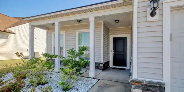 Image 4: Entrance to property with a porch and stone siding Image 4: Entrance to property with a porch and stone siding