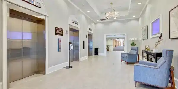 Image 2: Lobby with a high ceiling, recessed lighting, and
