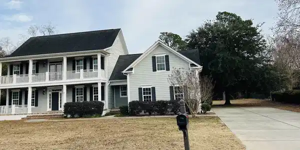 Image 2: View of front facade with a porch, a front yard, a