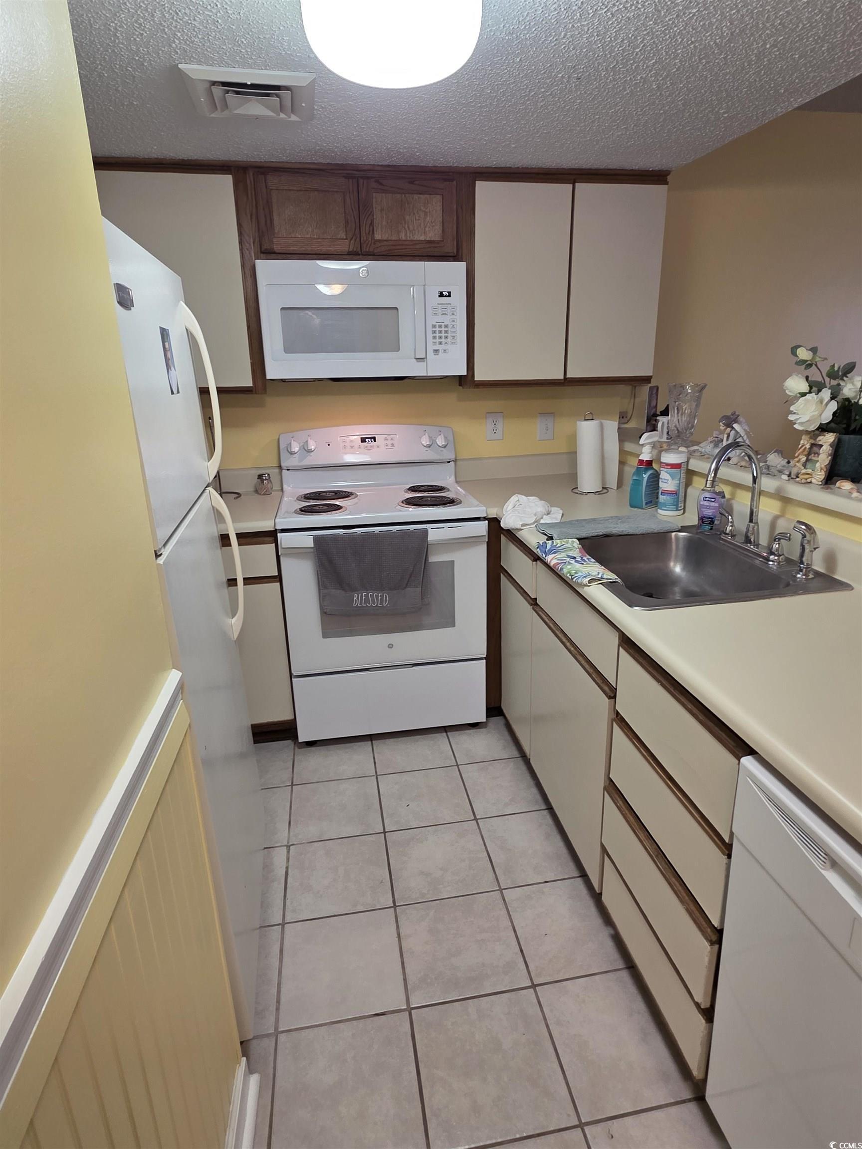 Image 4: Kitchen featuring white appliances, light tile pat Image 4: Kitchen featuring white appliances, light tile pat