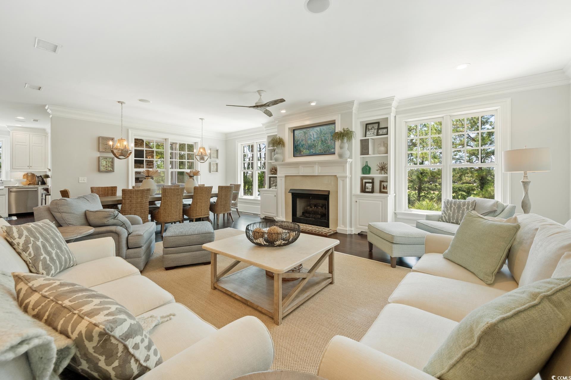 Image 3: Living area with crown molding, light wood-type fl
