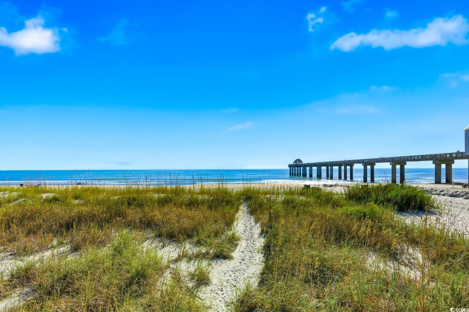 Image 3: Water view featuring local beach and a pier Image 3: Water view featuring local beach and a pier