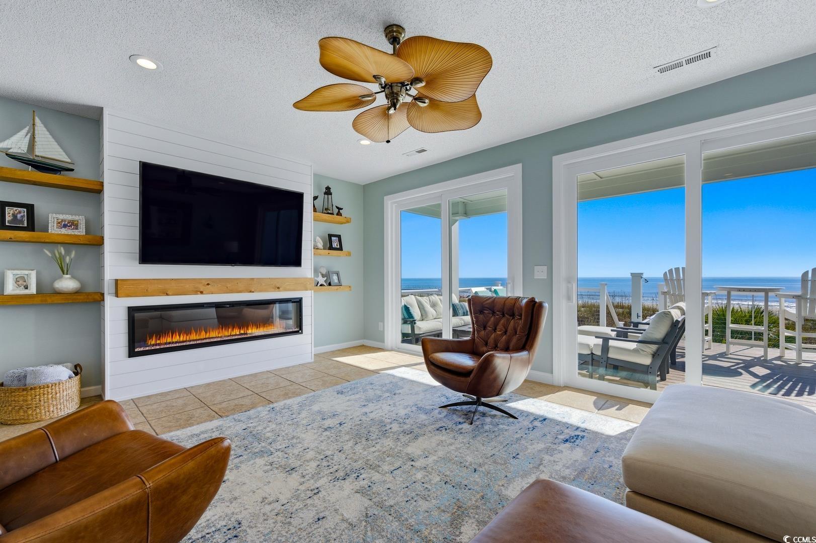 Image 4: Living room featuring a textured ceiling, light ti Image 4: Living room featuring a textured ceiling, light ti