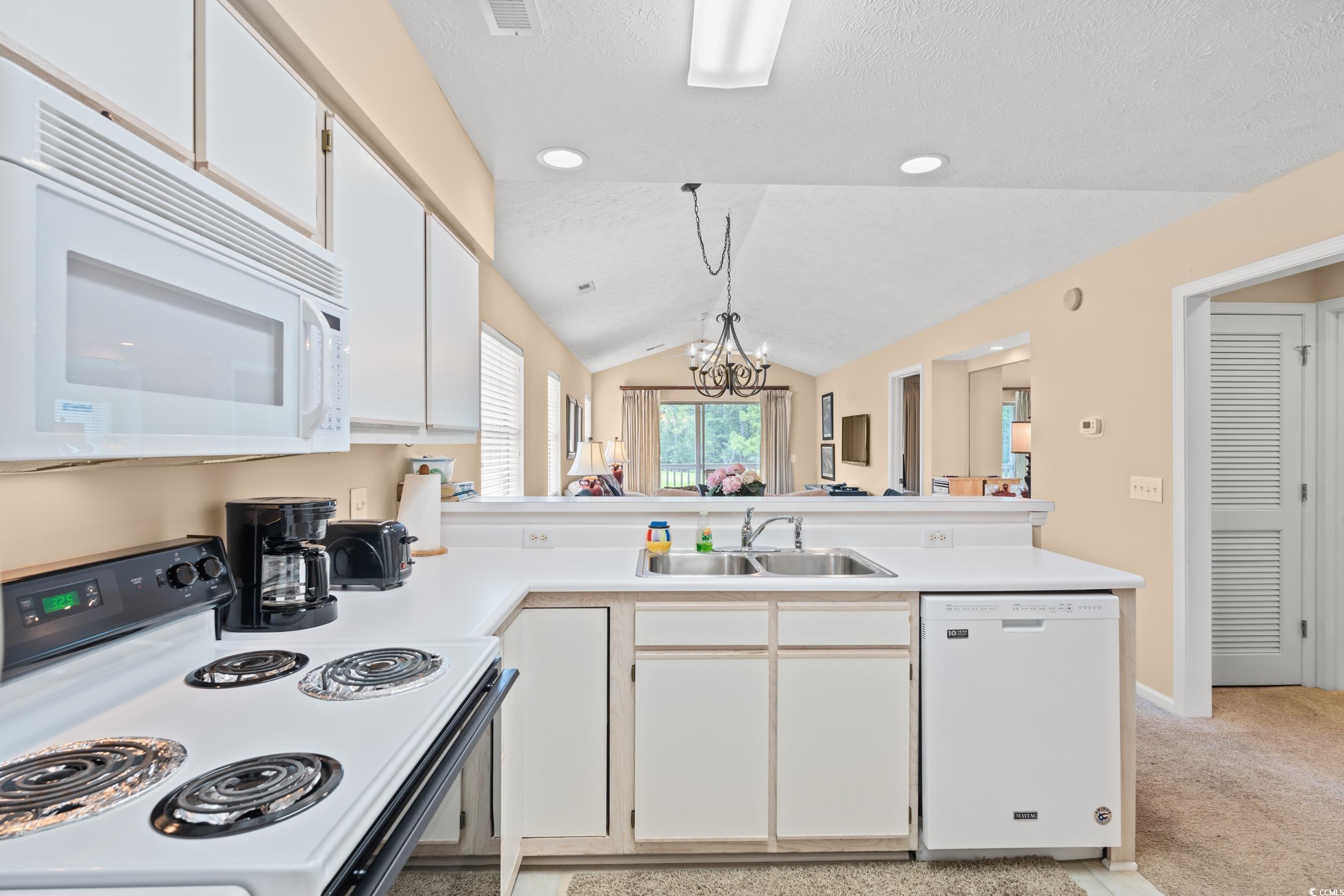 Image 2: Kitchen with white cabinets, white appliances, a p Image 2: Kitchen with white cabinets, white appliances, a p