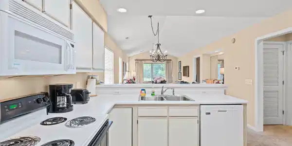 Image 2: Kitchen with white cabinets, white appliances, a p Image 2: Kitchen with white cabinets, white appliances, a p