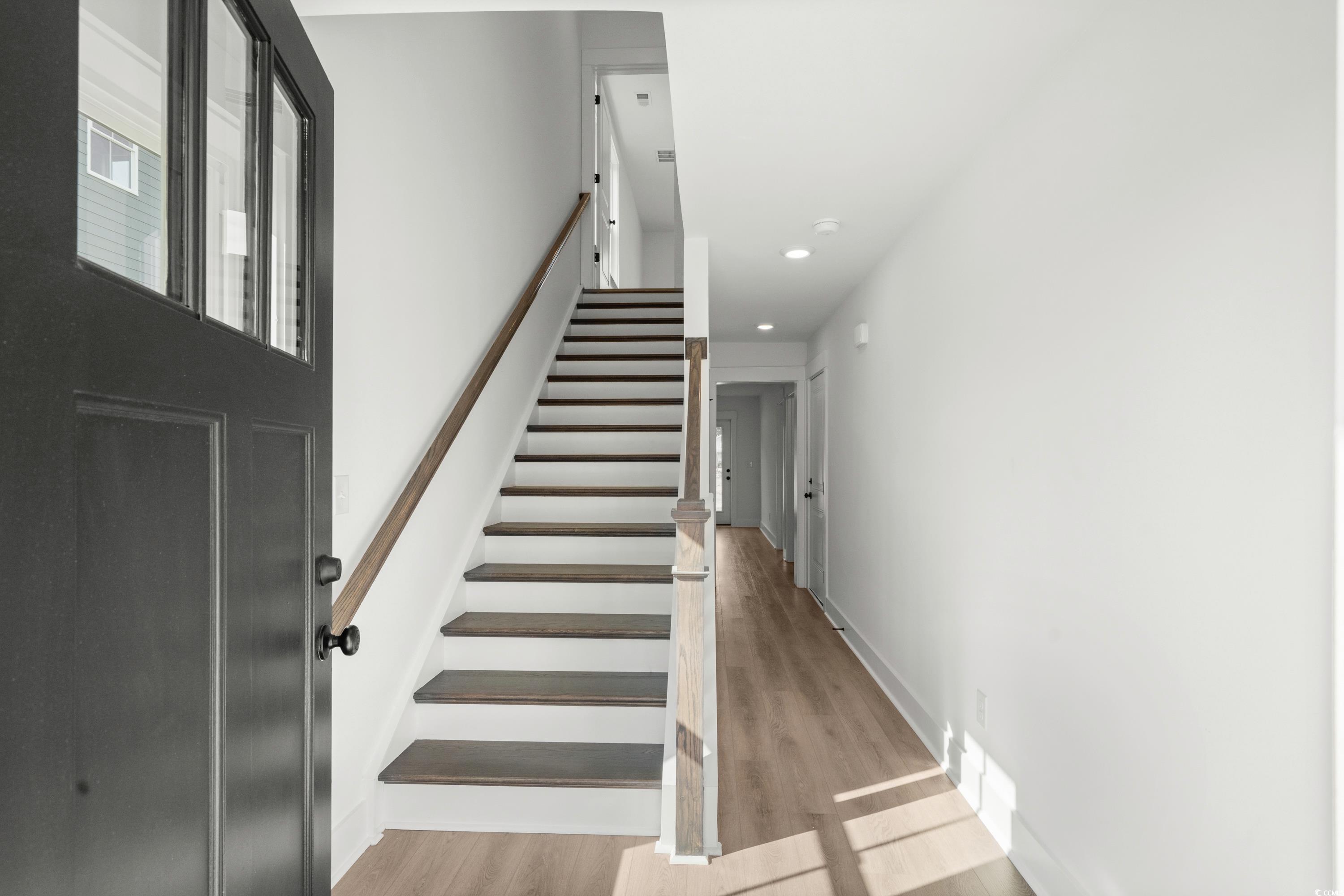 Image 4: Stairway featuring wood finished floors and recess