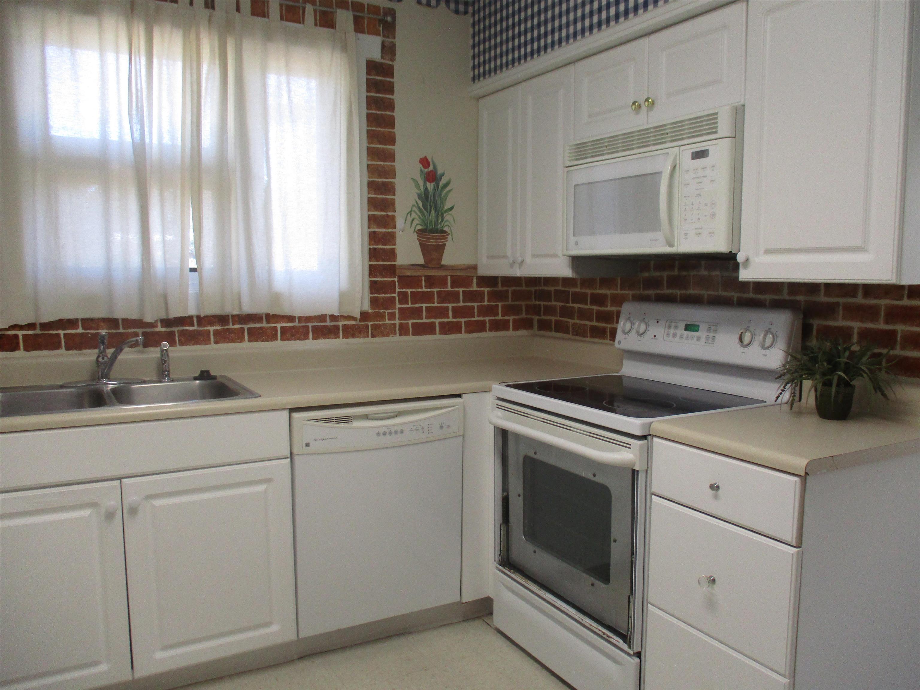 Image 4: Kitchen with white appliances, white cabinetry, li Image 4: Kitchen with white appliances, white cabinetry, li