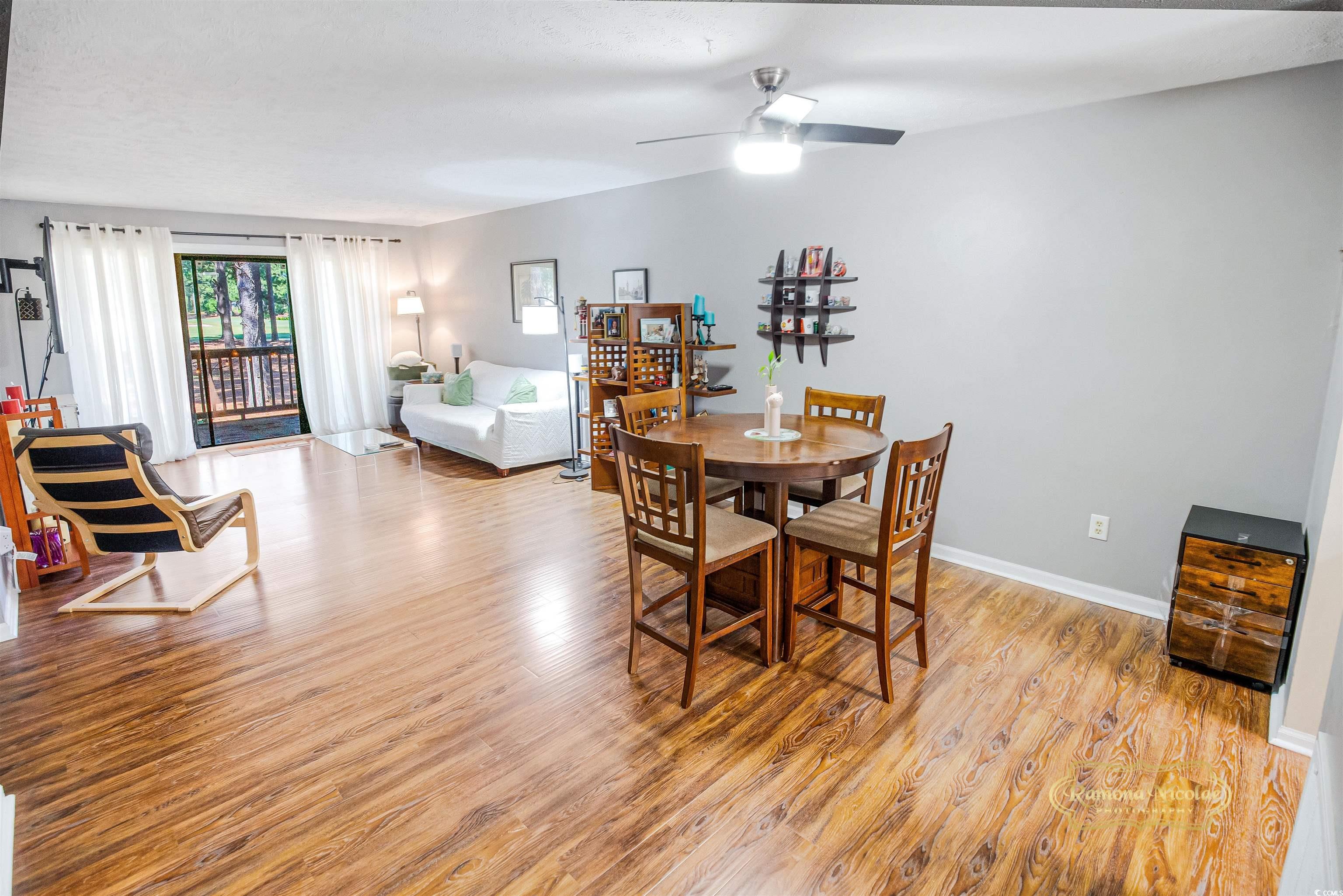 Image 4: Dining area with light wood-style flooring and cei