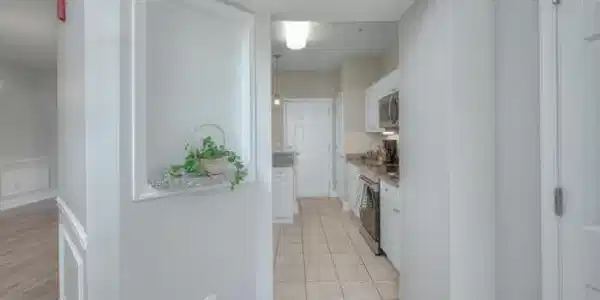 Image 2: Kitchen featuring white cabinetry, appliances with