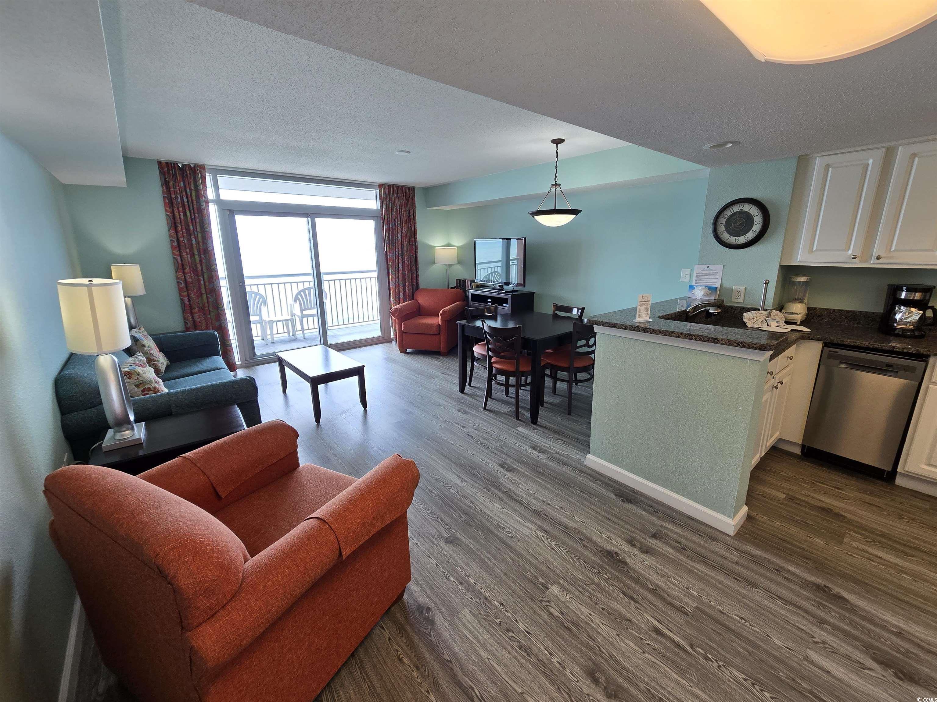 Image 2: Living area featuring a wall of windows, a texture Image 2: Living area featuring a wall of windows, a texture