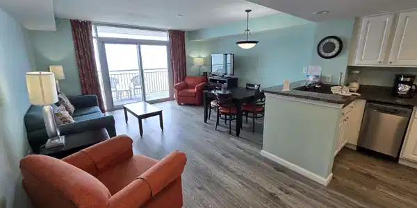 Image 2: Living area featuring a wall of windows, a texture