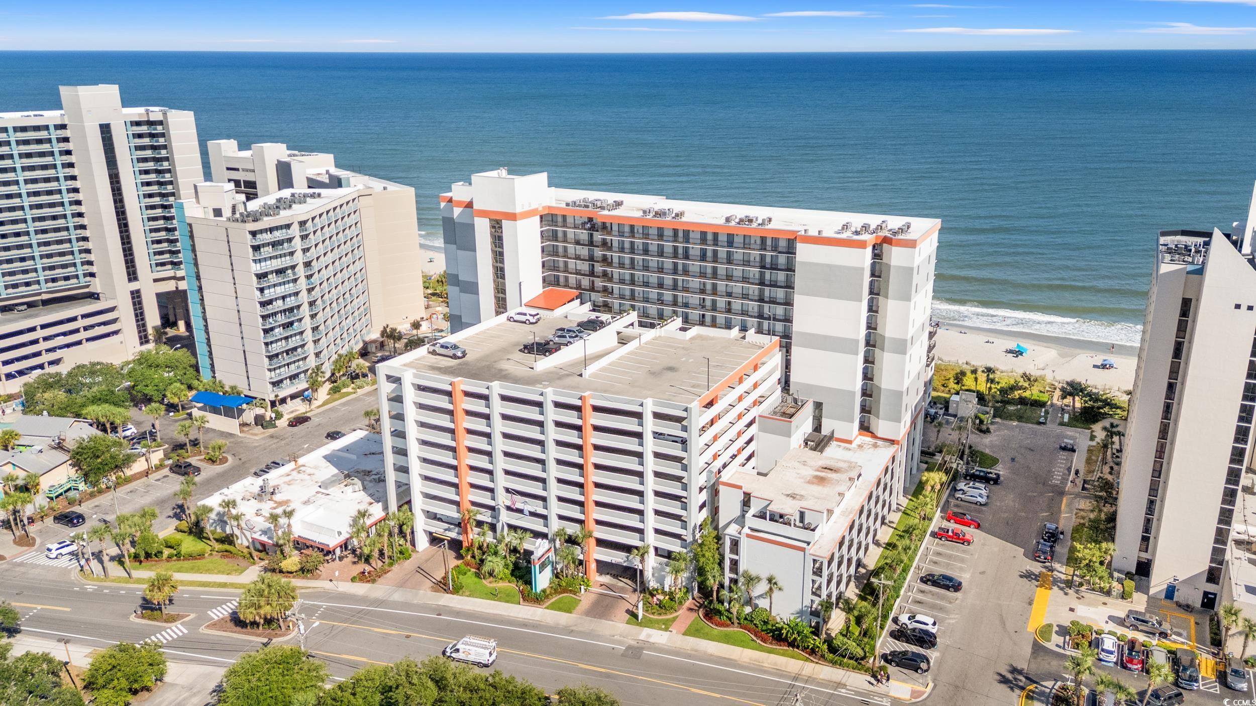 Image 2: Aerial view of expansive beach and apartment compl