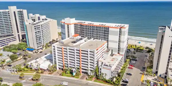 Image 2: Aerial view of expansive beach and apartment compl