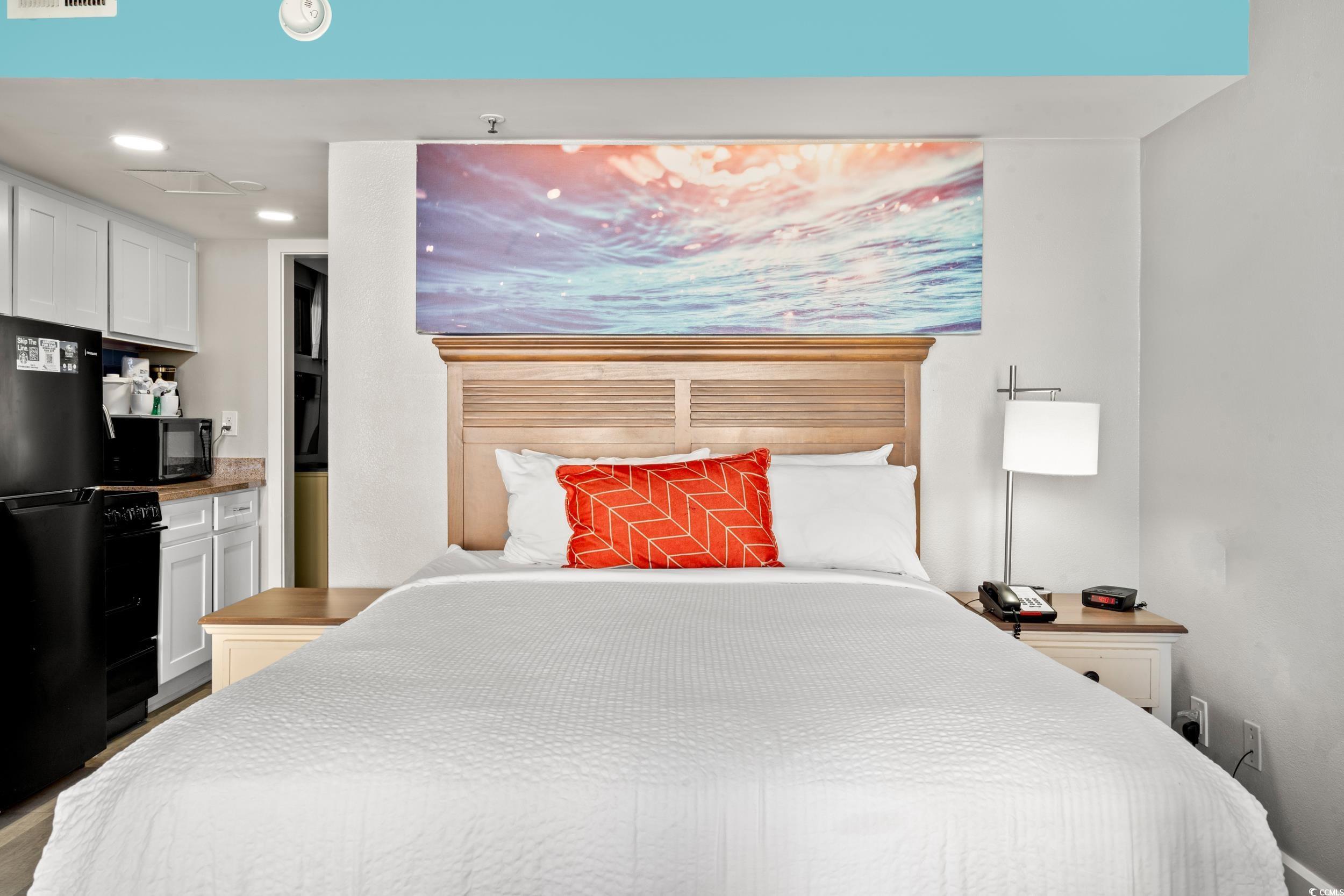 Image 4: Bedroom featuring freestanding refrigerator and re