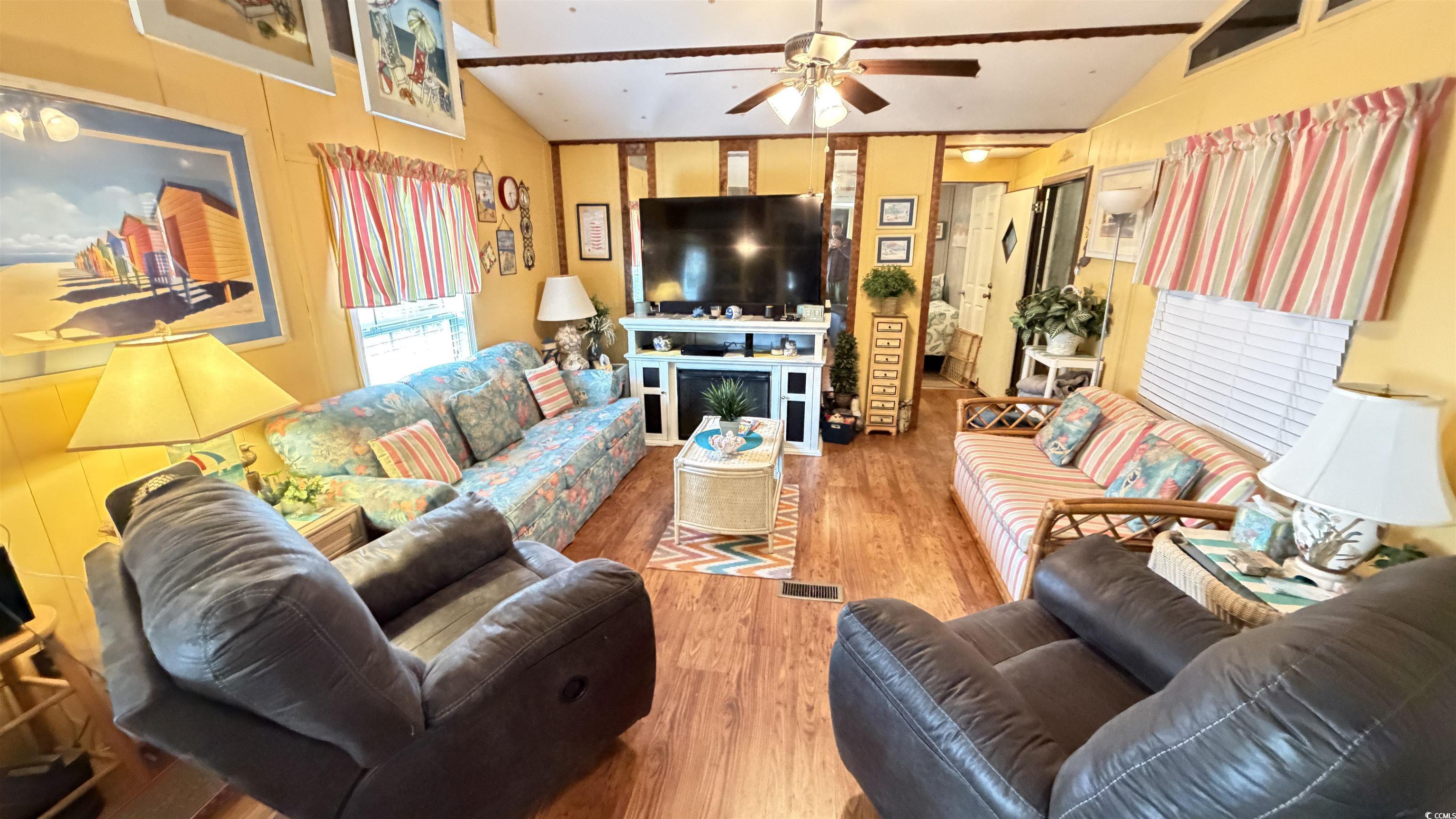 Image 3: Living area featuring lofted ceiling, wood finishe Image 3: Living area featuring lofted ceiling, wood finishe