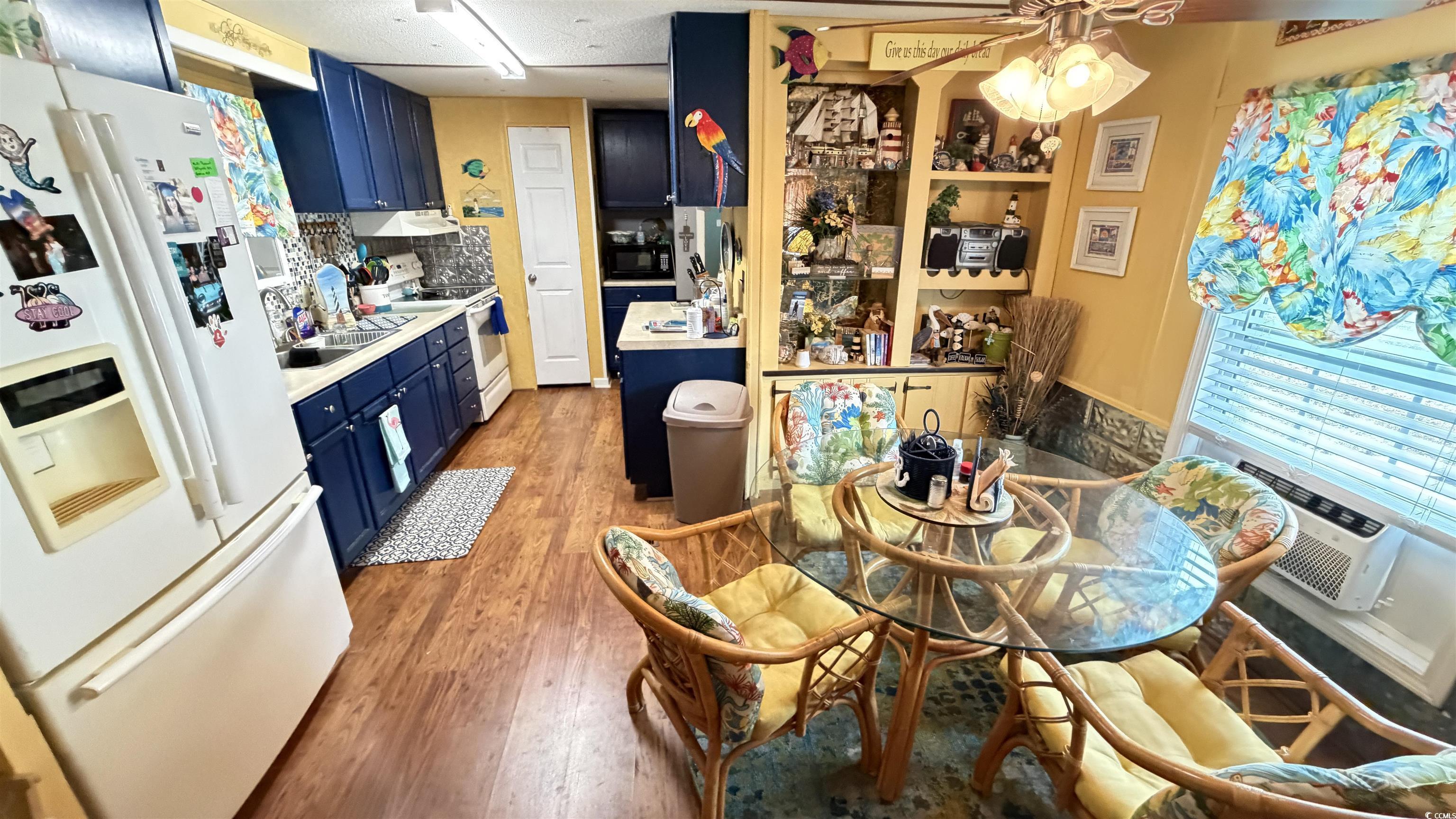 Image 4: Kitchen featuring blue cabinets, white appliances, Image 4: Kitchen featuring blue cabinets, white appliances,