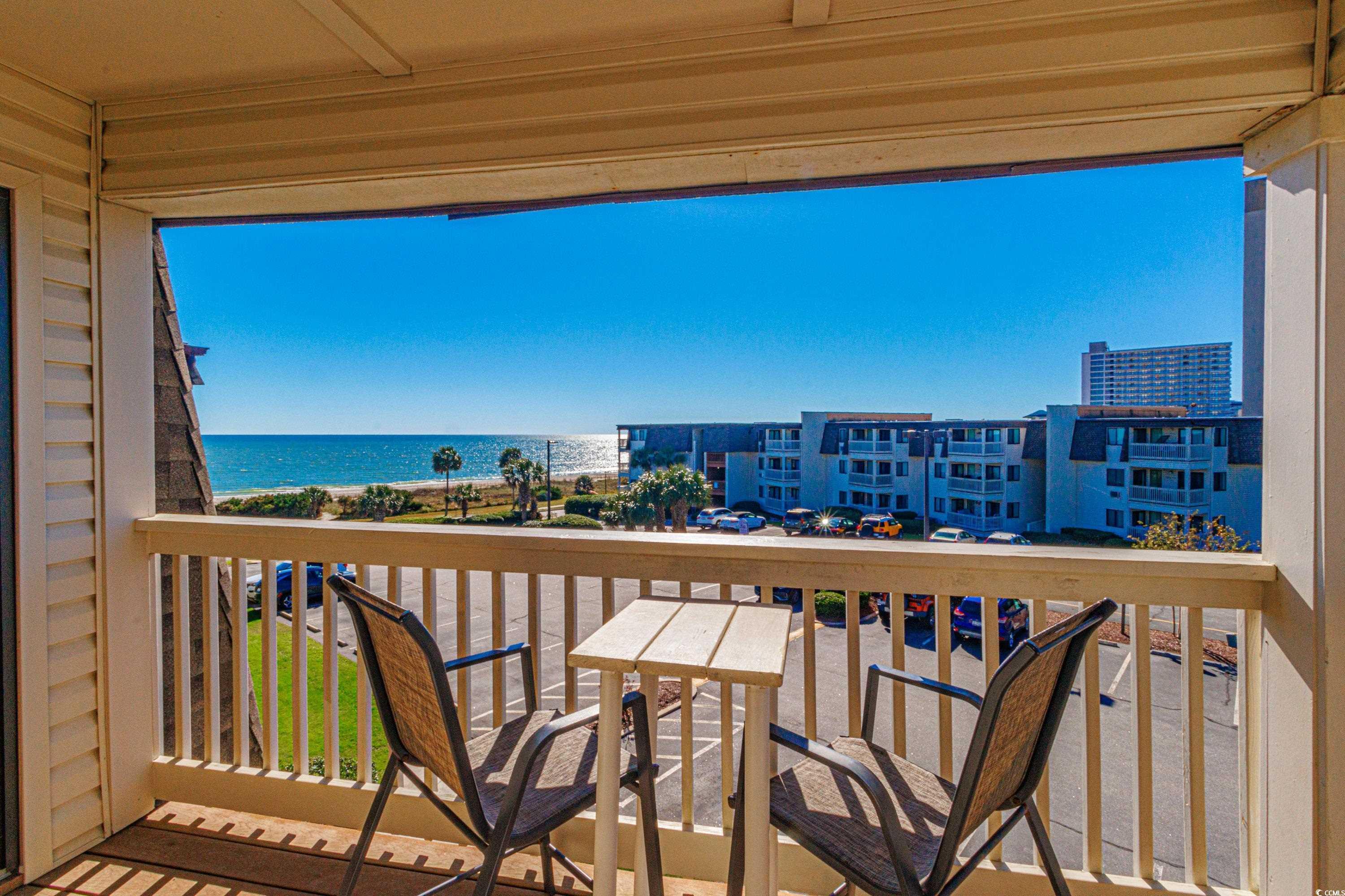 Image 2: Balcony featuring a water view