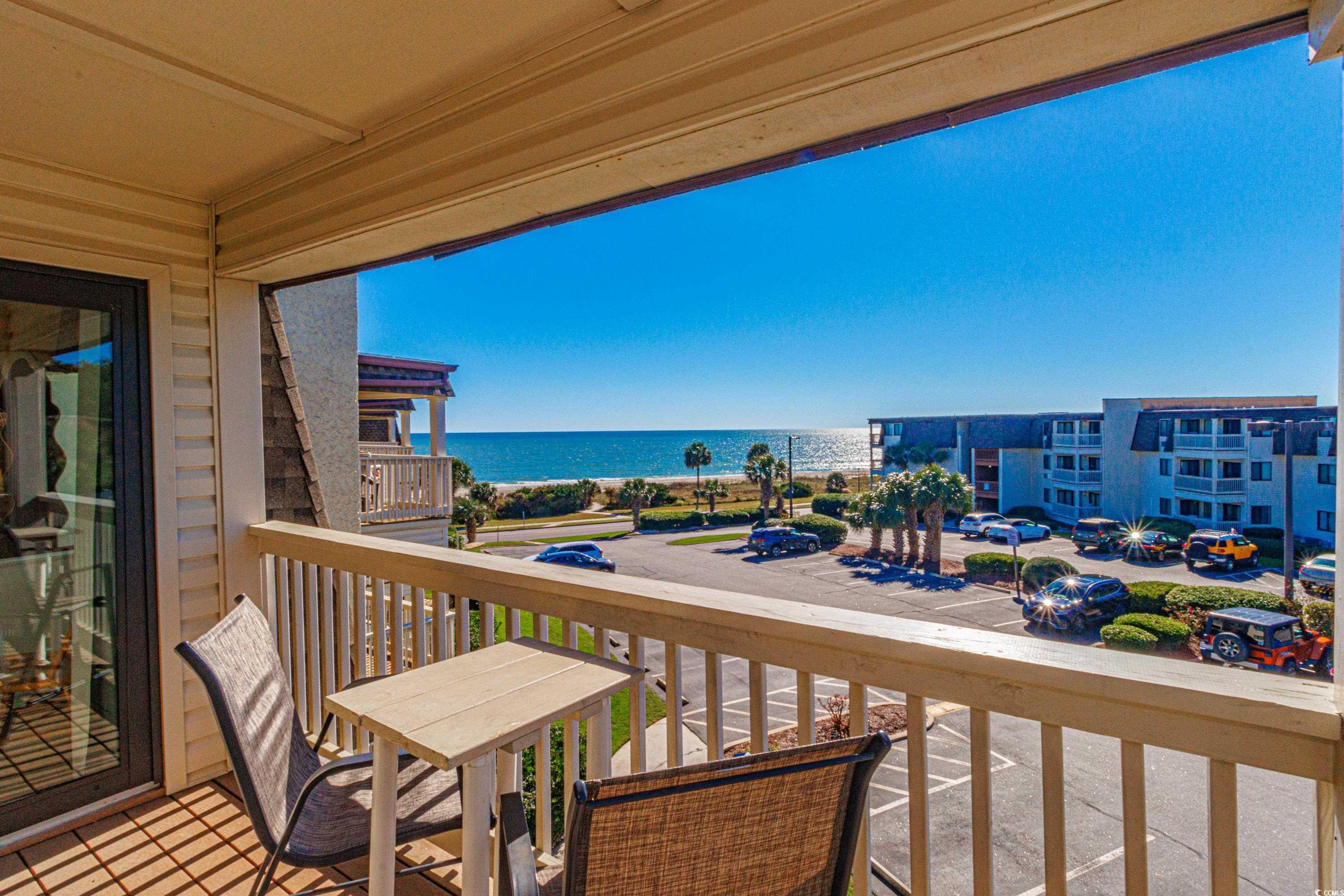 Image 3: Balcony featuring a water view