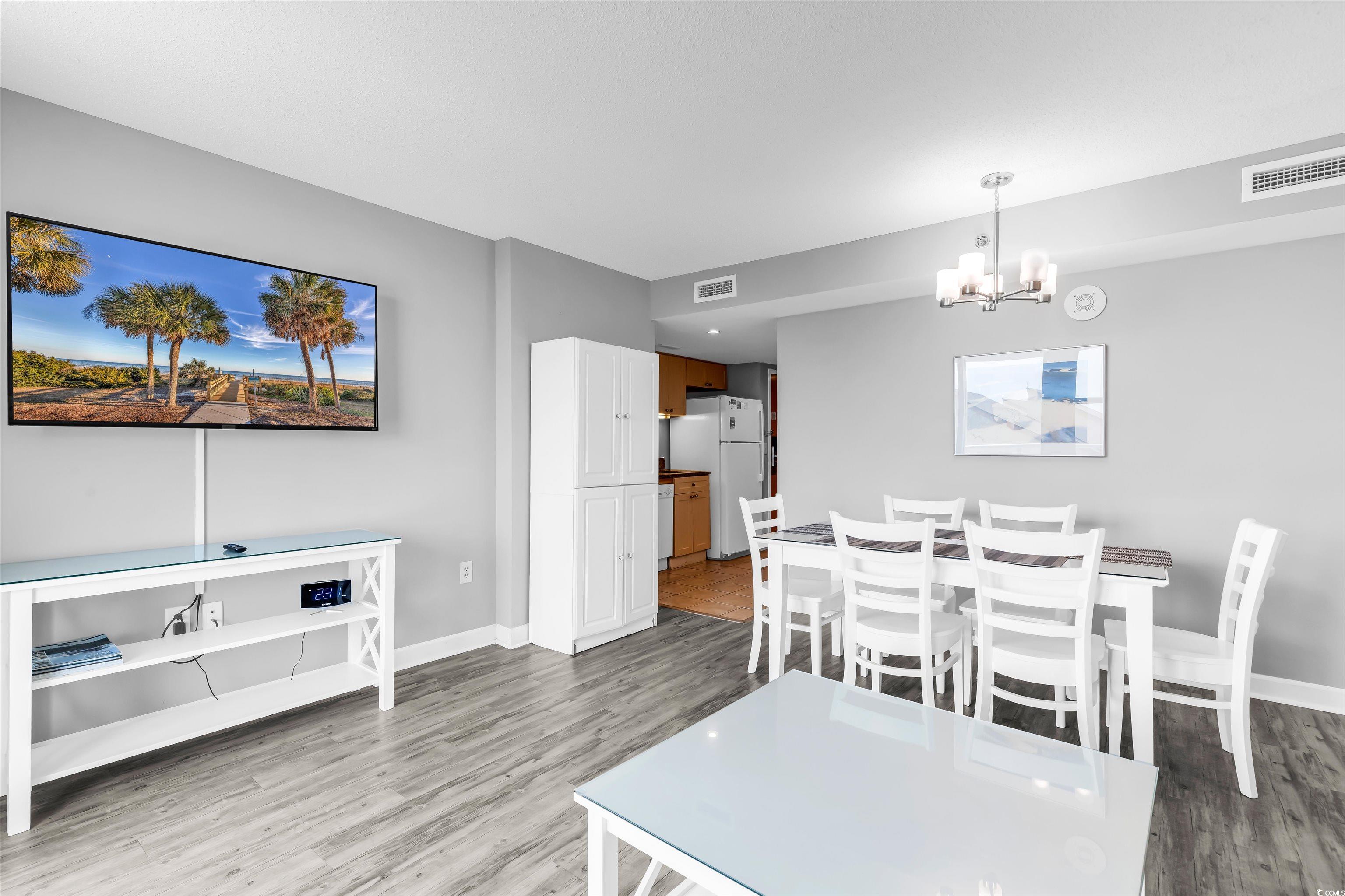 Image 2: Dining area with wood finished floors, a chandelie Image 2: Dining area with wood finished floors, a chandelie