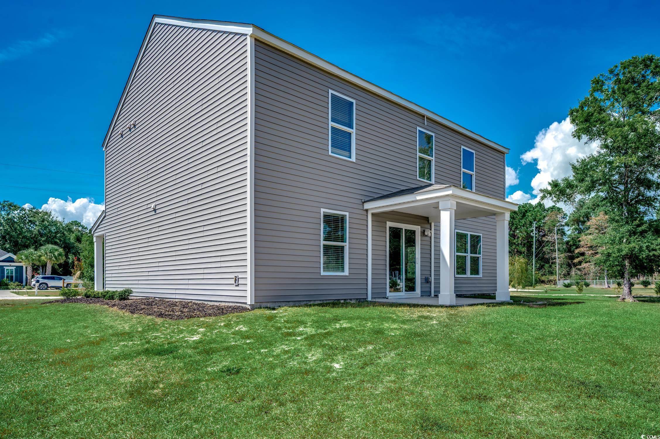 Image 2: Back of property featuring a patio area and a lawn Image 2: Back of property featuring a patio area and a lawn