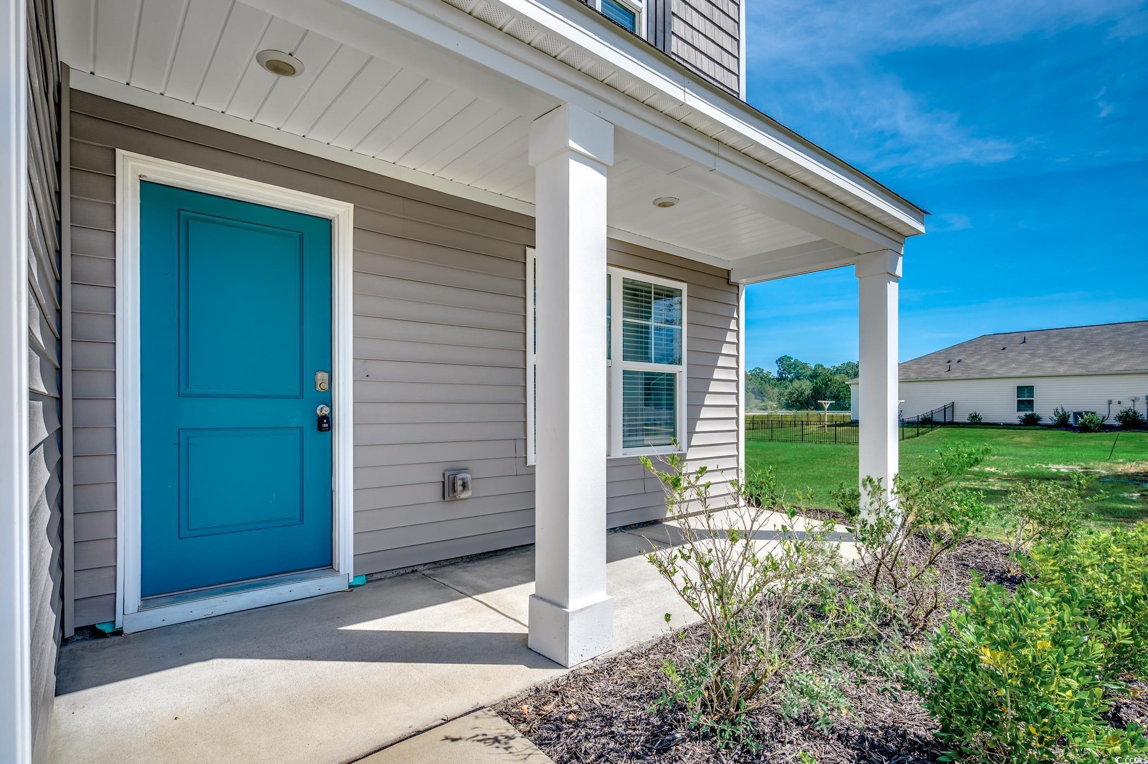 Image 4: Doorway to property with a porch and a lawn Image 4: Doorway to property with a porch and a lawn