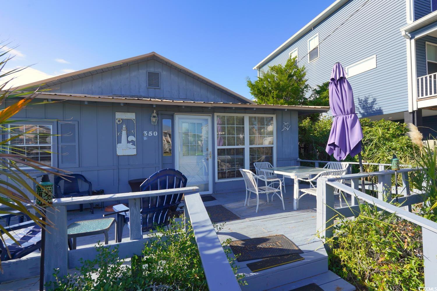 Image 4: Wooden terrace featuring outdoor dining space