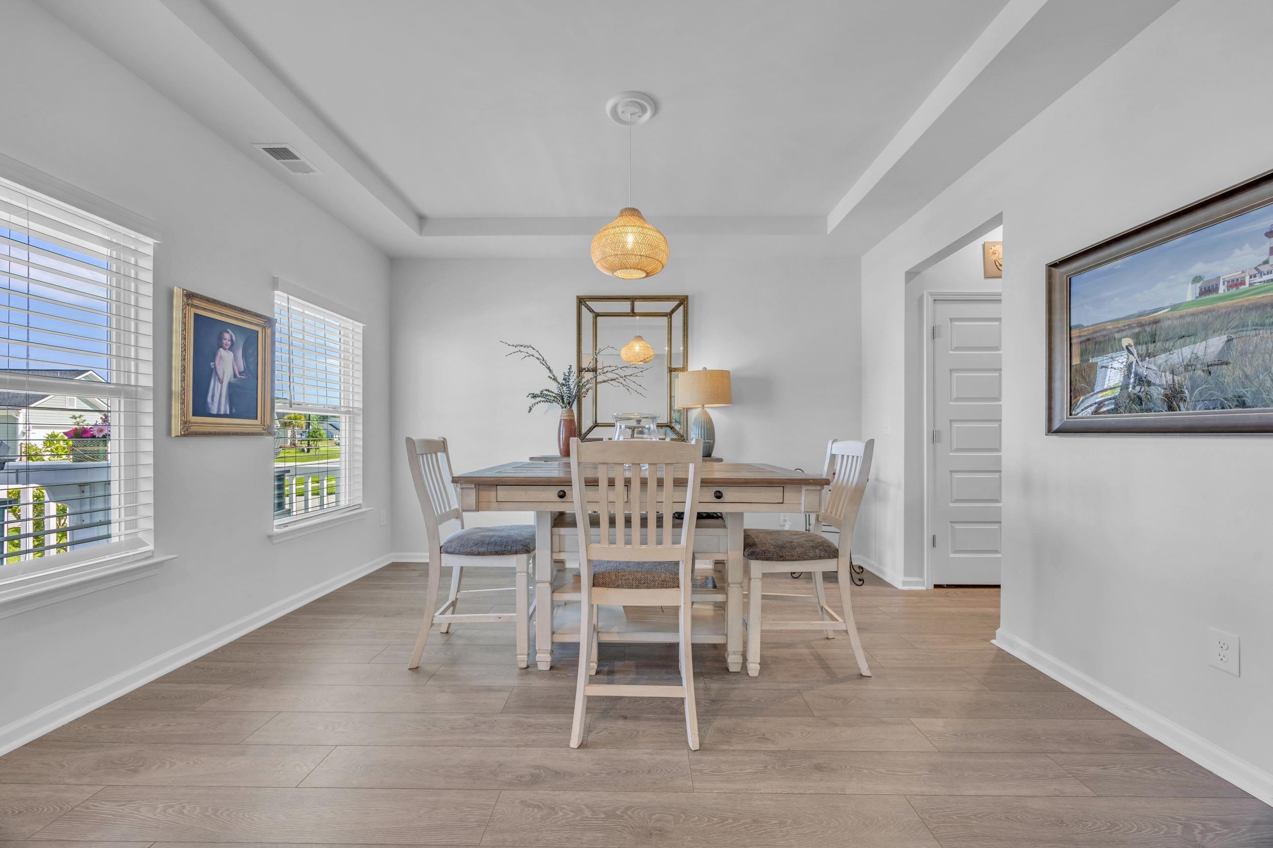 Image 4: Dining room with light wood-style flooring and a r