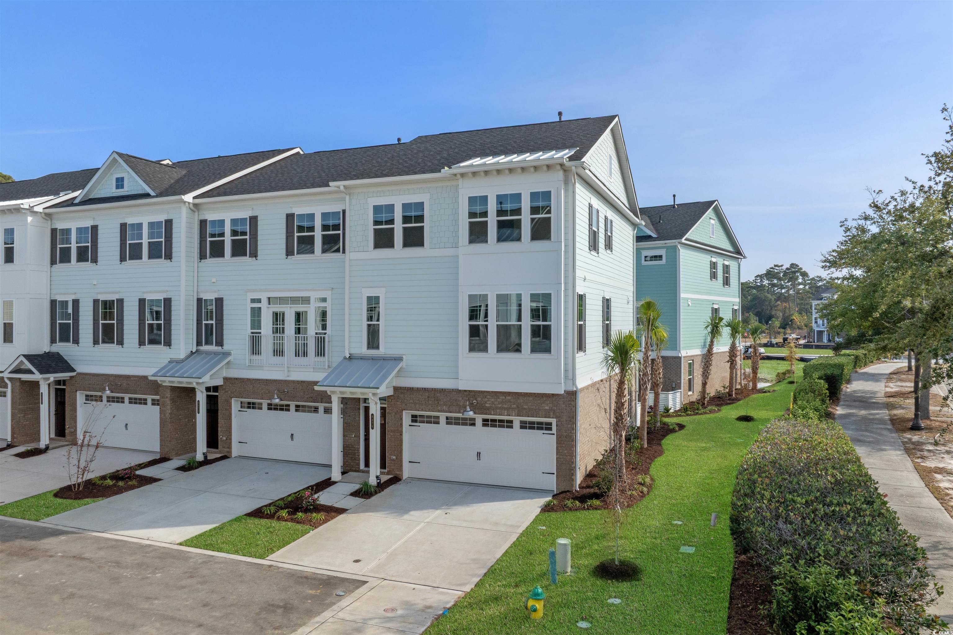 Image 4: View of front facade with brick siding, driveway, Image 4: View of front facade with brick siding, driveway,