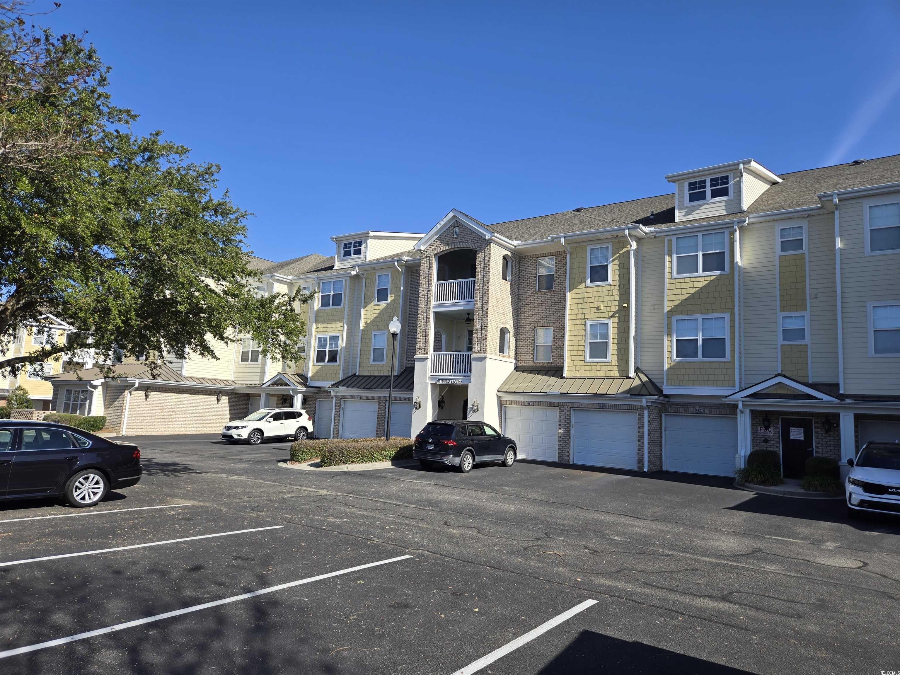 Image 1: View of building exterior with uncovered parking a Image 1: View of building exterior with uncovered parking a