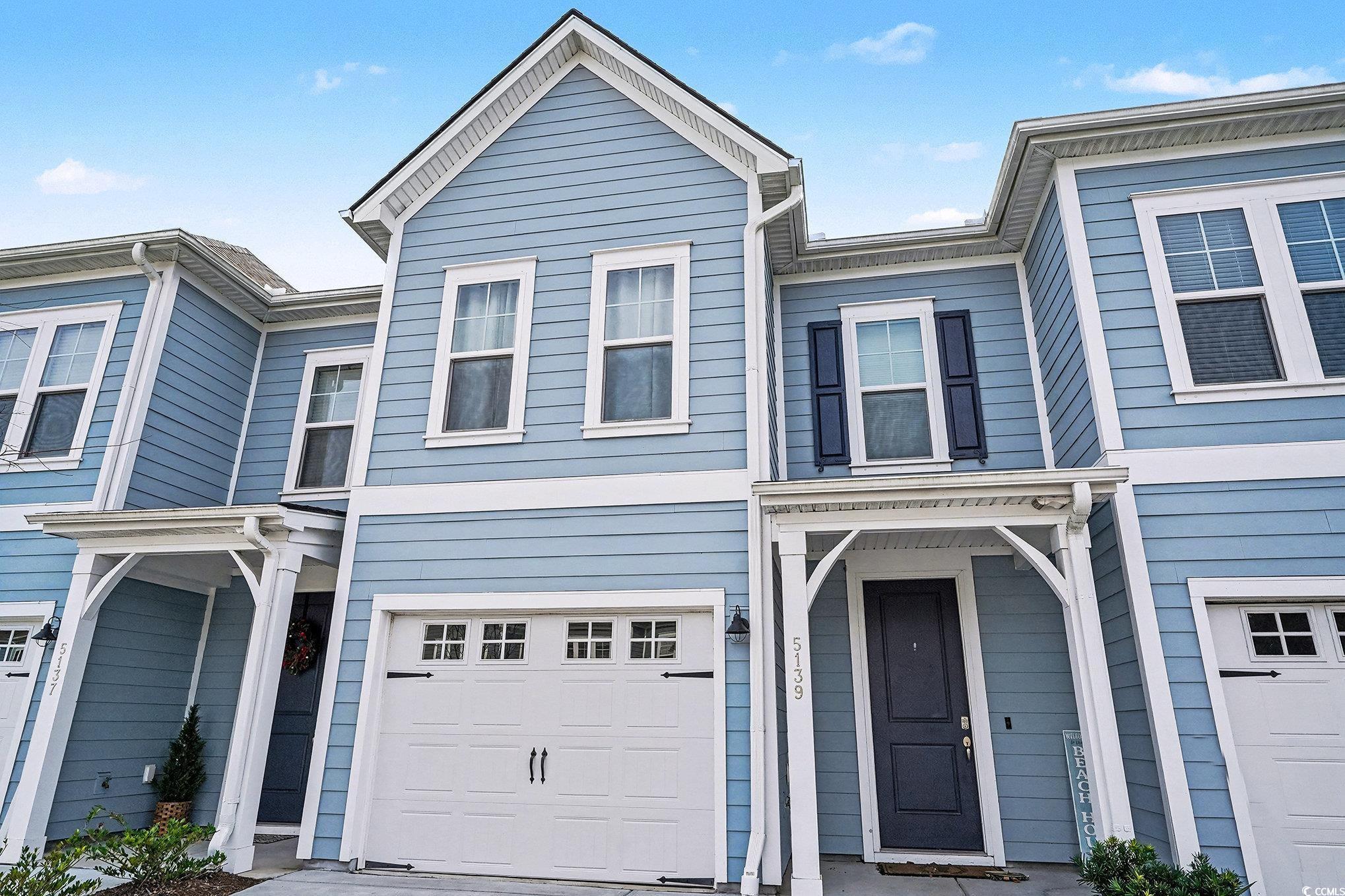 Image 1: View of front of property featuring an attached ga Image 1: View of front of property featuring an attached ga