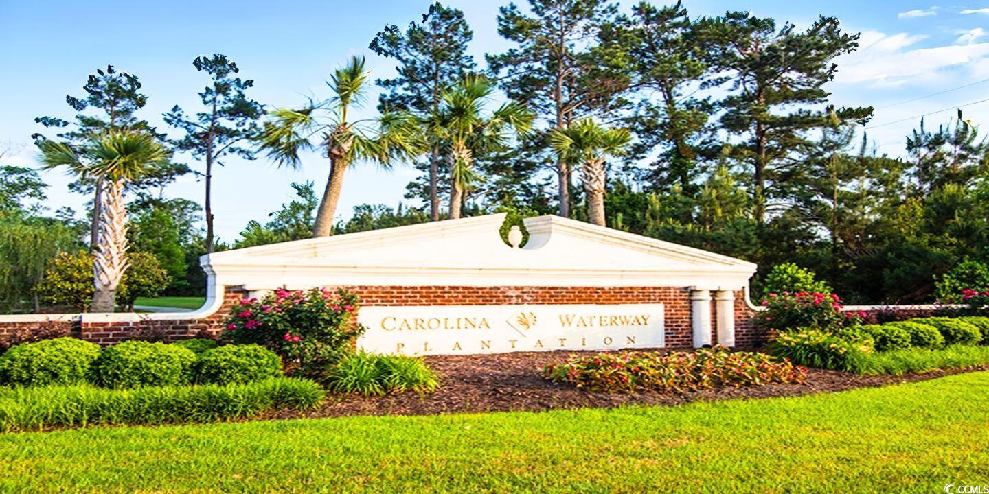 Image 4: Community sign with a yard and a garage