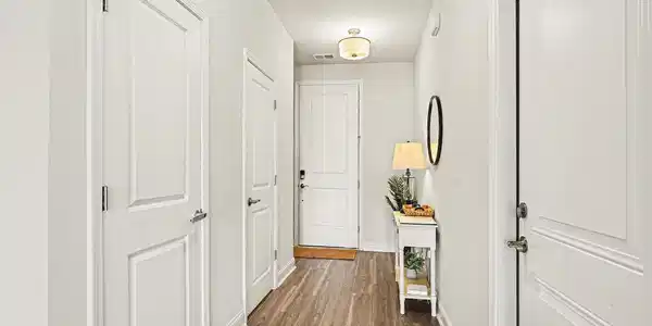 Image 2: Hallway with dark wood-style floors and baseboards
