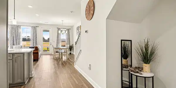 Image 3: Hallway with dark wood-style floors and recessed l