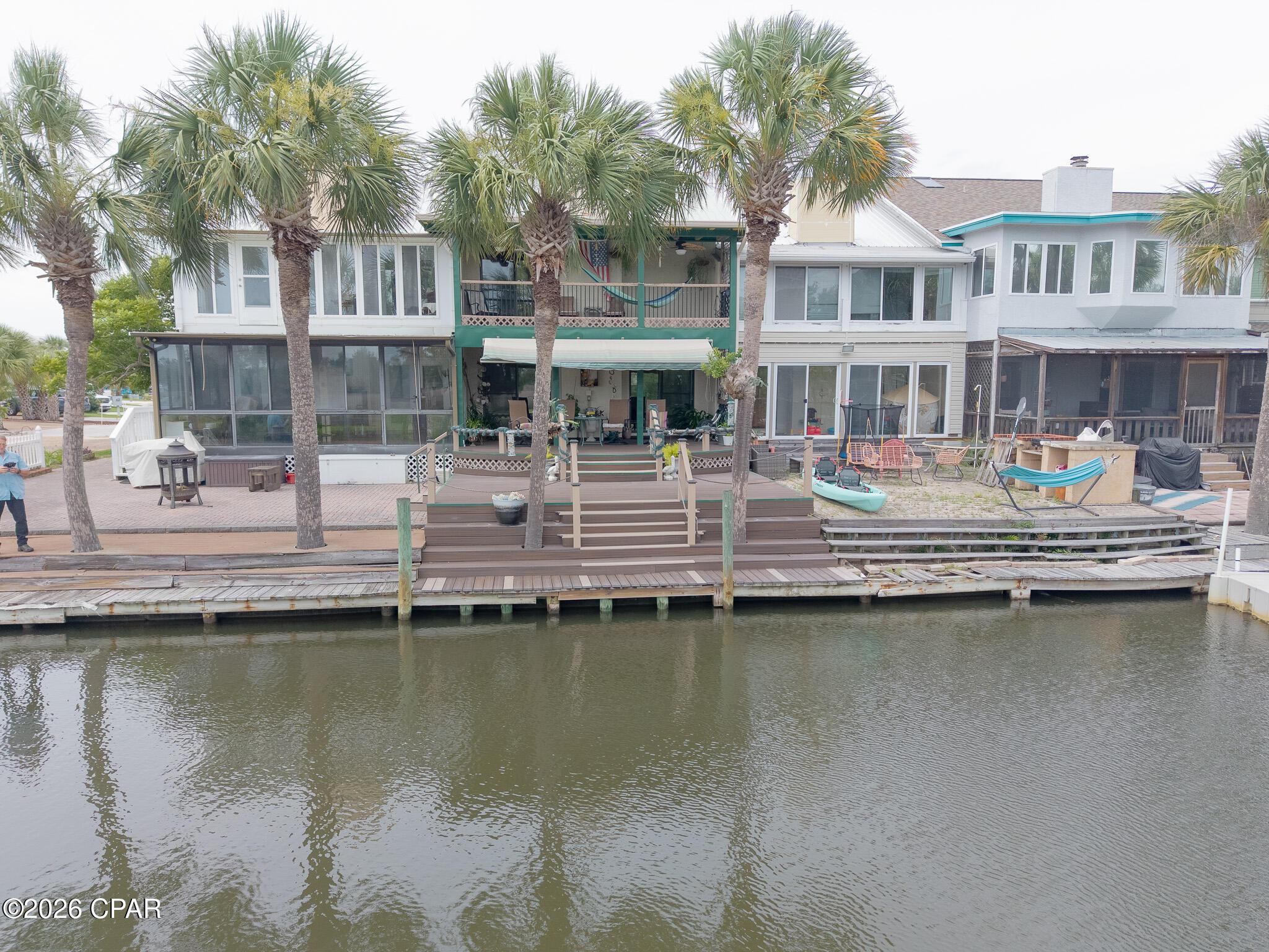 Image 1: 1227 Capri Dr Drone Canal & Porch 6-7-26