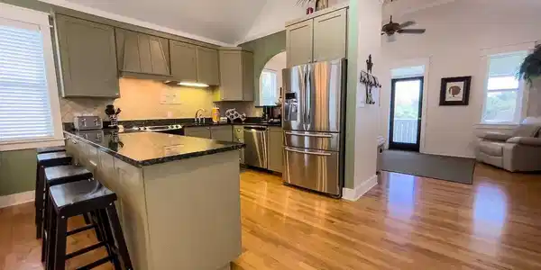 Image 3: Kitchen with sage cabinets