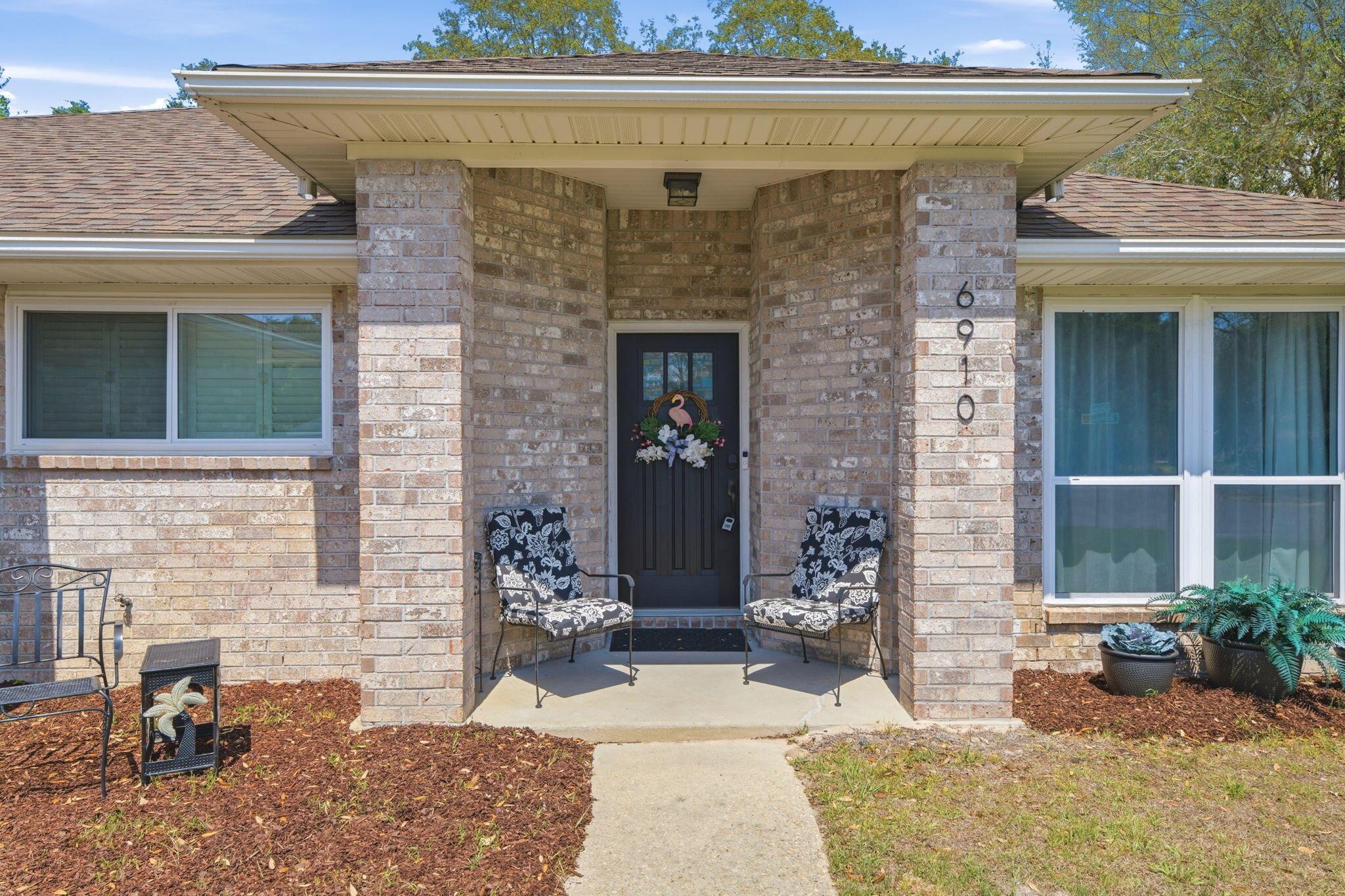 Image 2: All brick home with gutters